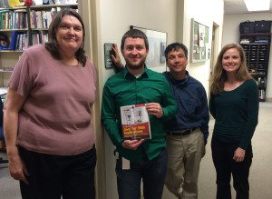 Nick Williams gifts copies of the book to Dr. Bill Hooper, Dr. Sarah Ann Fleming and Dr. Joyce Crowell in the Department of Mathematics and Computer Science.
