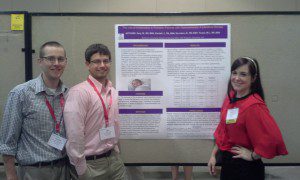 Saunders, Kendall and Gray with their poster.