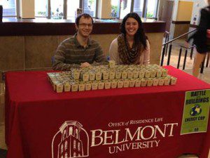 ( L – R) Residence Hall Directors Nathan Hendrix and Danielle Steffa pass out marigolds to students