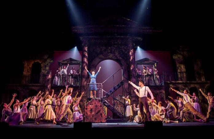 Photo of cast on-stage during a performance of Evita