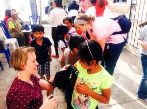 Student taking blood pressure of Guatemalan child