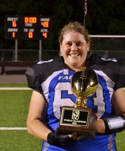 Nanney holding the world championship trophy from the independent women's football league