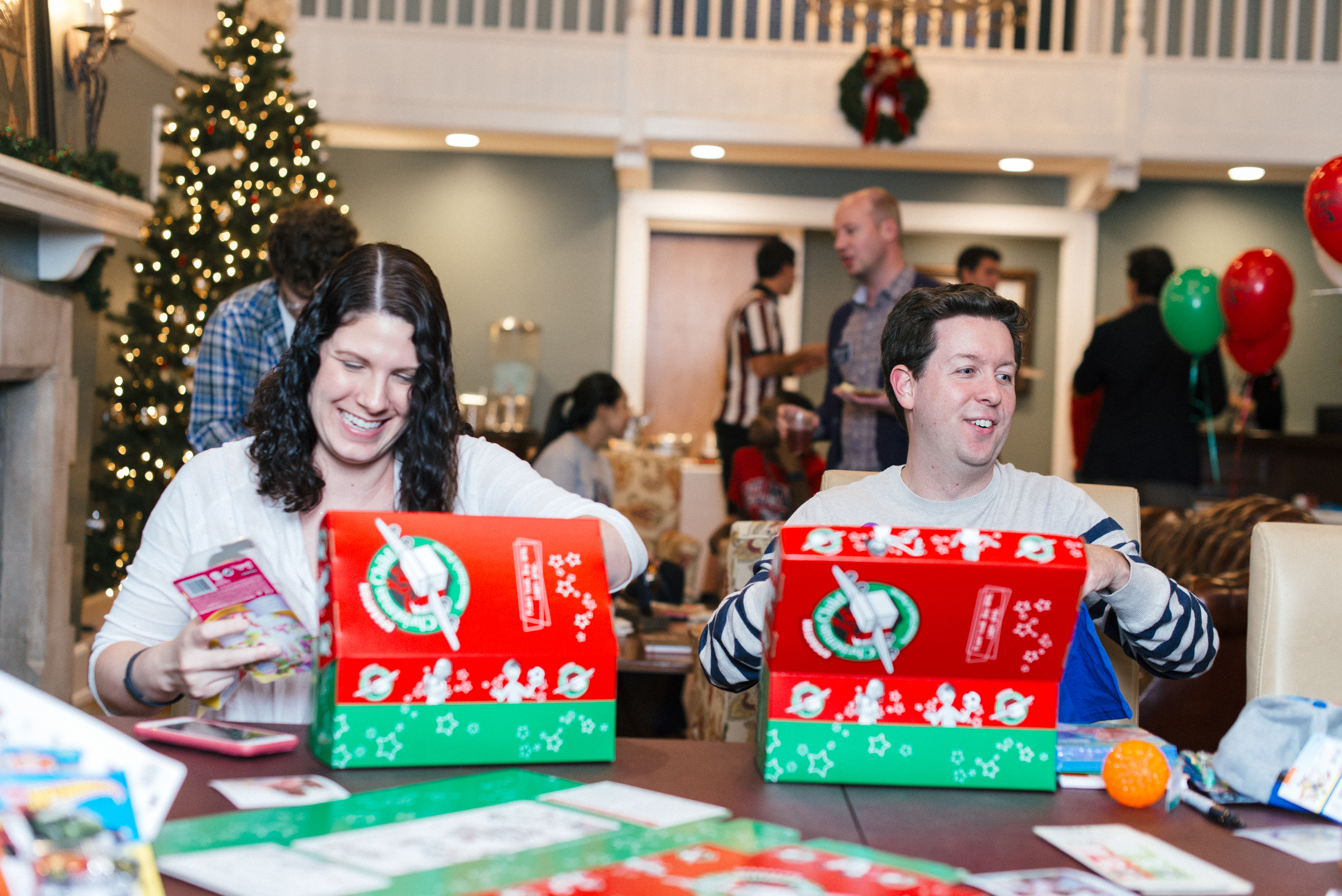Alumni pack Operation Christmas Child boxes in the Foutch Alumni House.
