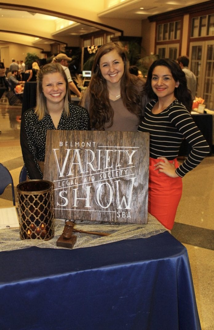 Students standing around the variety show sign