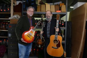 George Gruhn and Doug Howard hold a 1923 Gibson F-5 Lloyd Loar mandolin, 1960 Les Paul Standard "Burst" electric guitar and 1939 Martin D-45 acoustic guitar that have been donated to Belmont University at Gruhn Guitars in Nashville, Tenn. November 8, 2016.