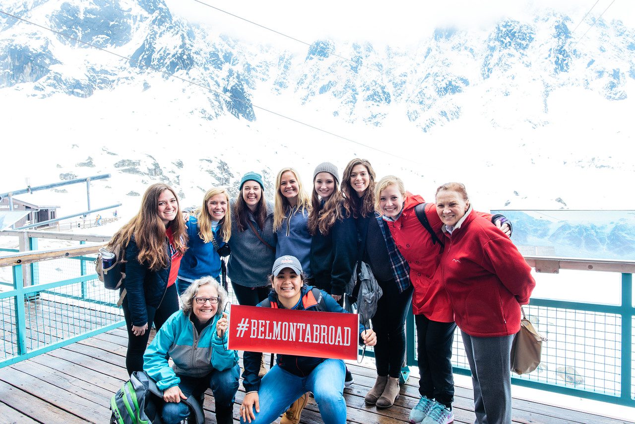 Students holding a sign that says "Belmont Abroad" in Switzerland