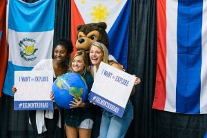 Students pose with Bruiser at Study Abroad Fair.