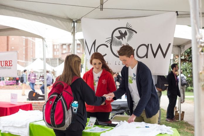 Students promoting their business at a booth on campus