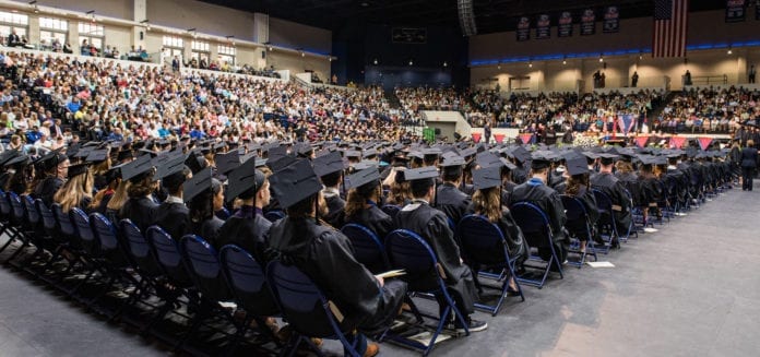 Students in their caps and gowns at Belmont's graduation in the Curb Event Center