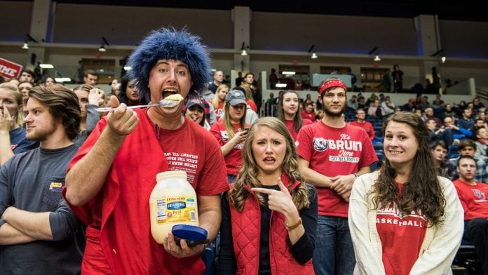 Spencer-Orrell holding a giant spoon of mayonnaise at the women's basketball game