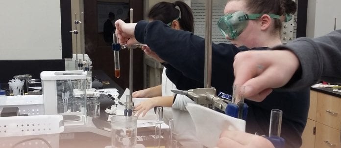 High school students perform science experiments on Belmont's campus.
