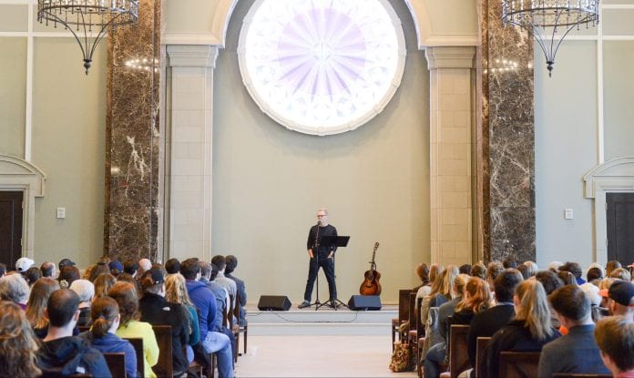 Chapman speaking to students at Chapel