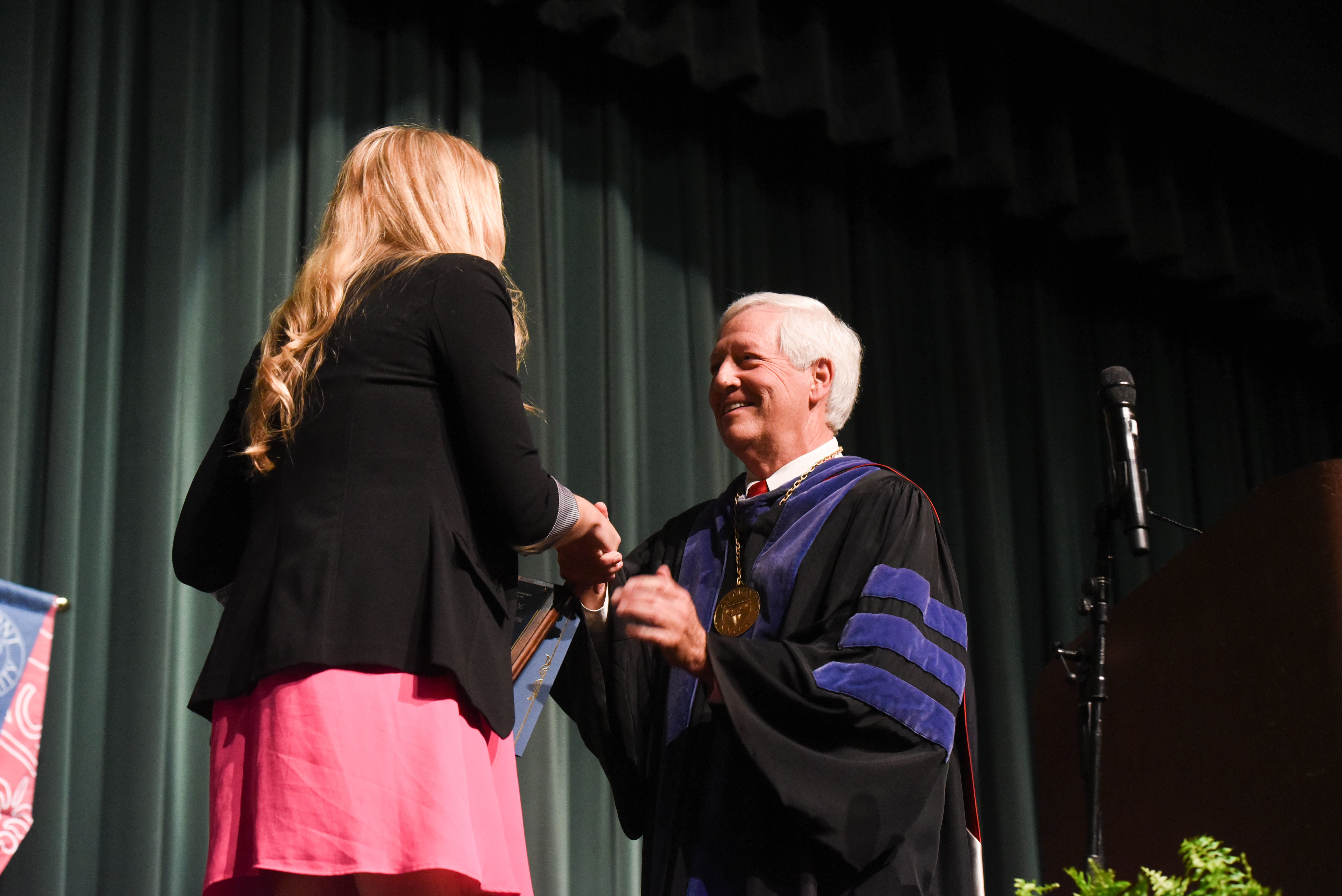 Dr. Fisher presents a student with the Fourth Year Student of the Year Award at the Annual Scholarship and Awards Day