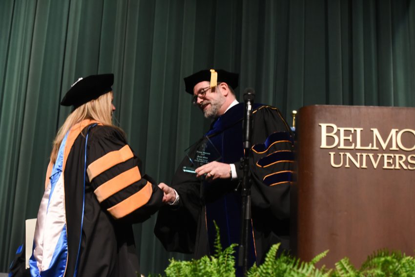 Dr. Adam receives her award from Provost Dr. Thomas Burns