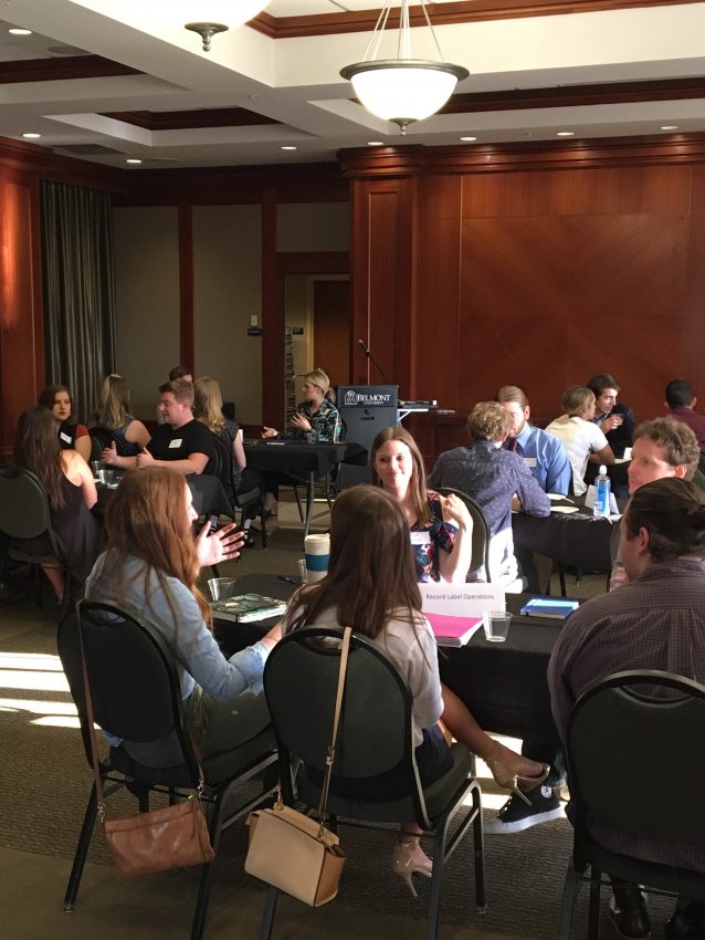 Attendees speak with industry experts at a recent event where professionals shared advice with soon-to-be-grads