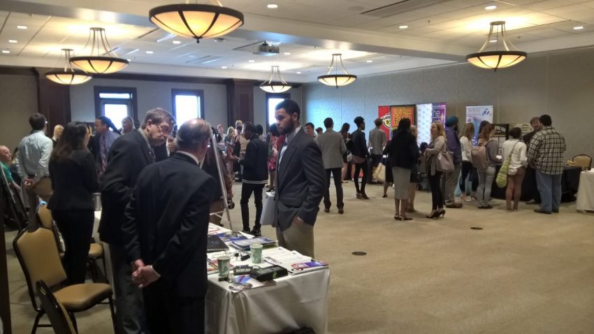 Students conversing with media organizations at the Career Fair