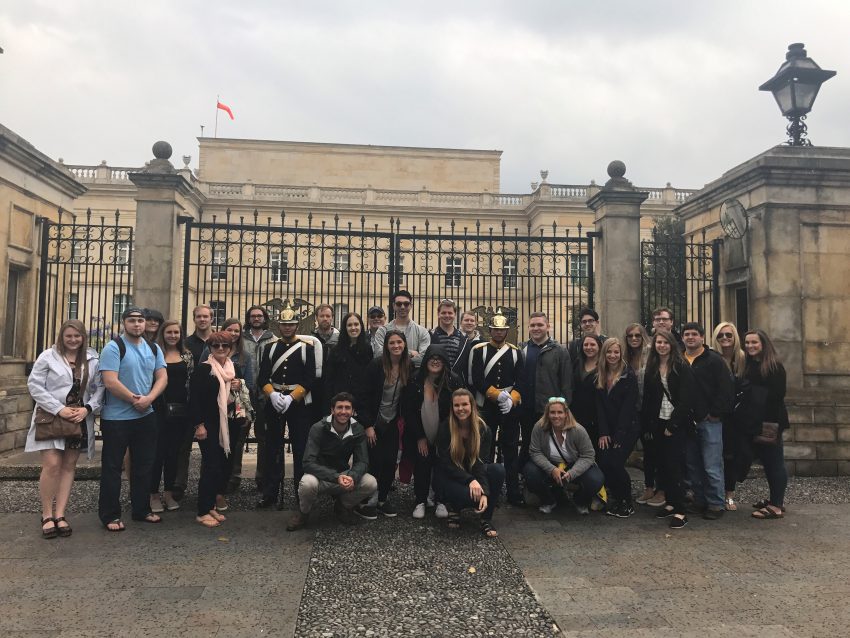 Students pose in front of the Presidential Palace in Bogota, Colombia
