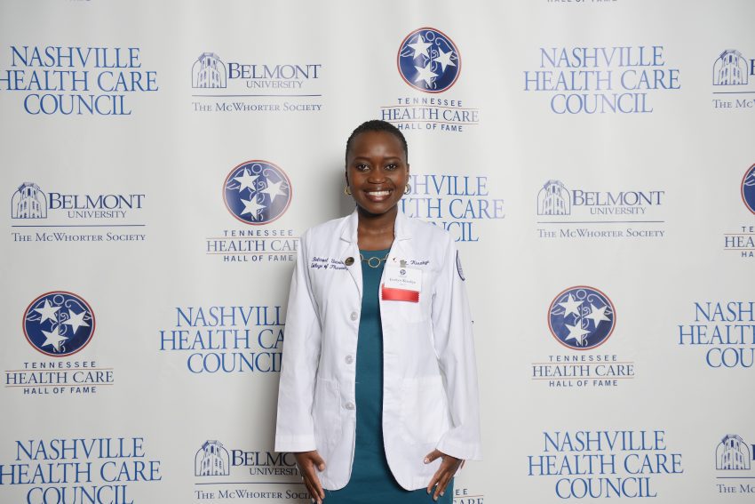 Kisakye, the award recipient, stands in front of a step and repeat at the 2016 Tennessee Health Care Hall of Fame Luncheon