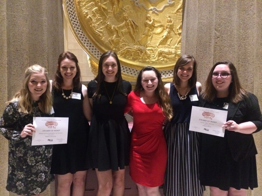 Award recipients pose with their honors