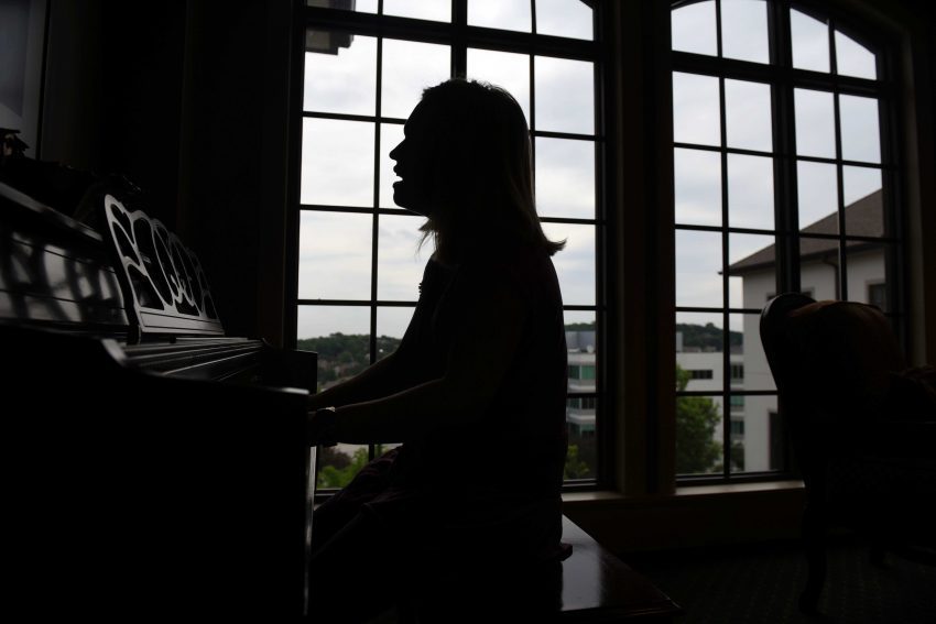 A silhouette image of Falvey performing at Brookside's piano.