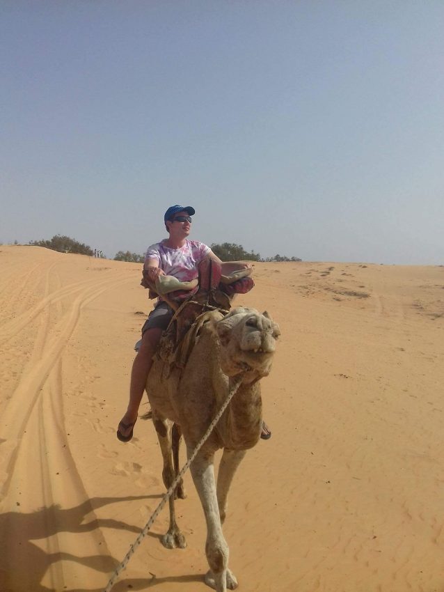 Grossnickle rides a camel while in Senegal. 