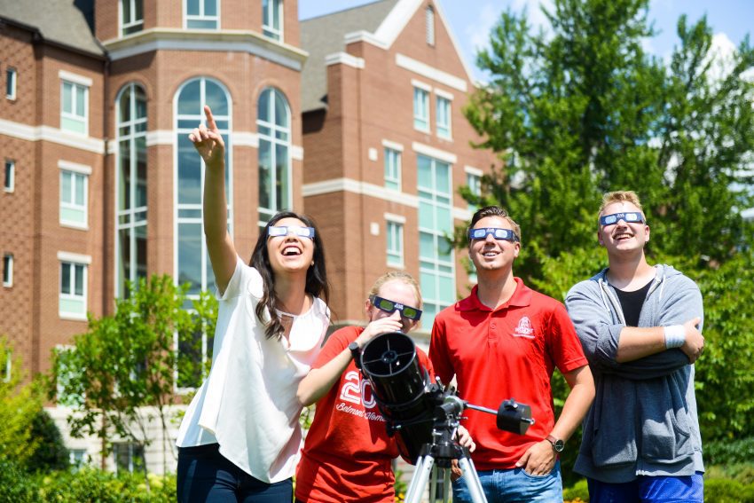 Students on the lawn, preparing for the eclipse viewing.