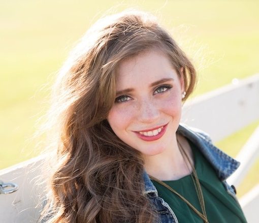 Linde LaChance leaning on a fence