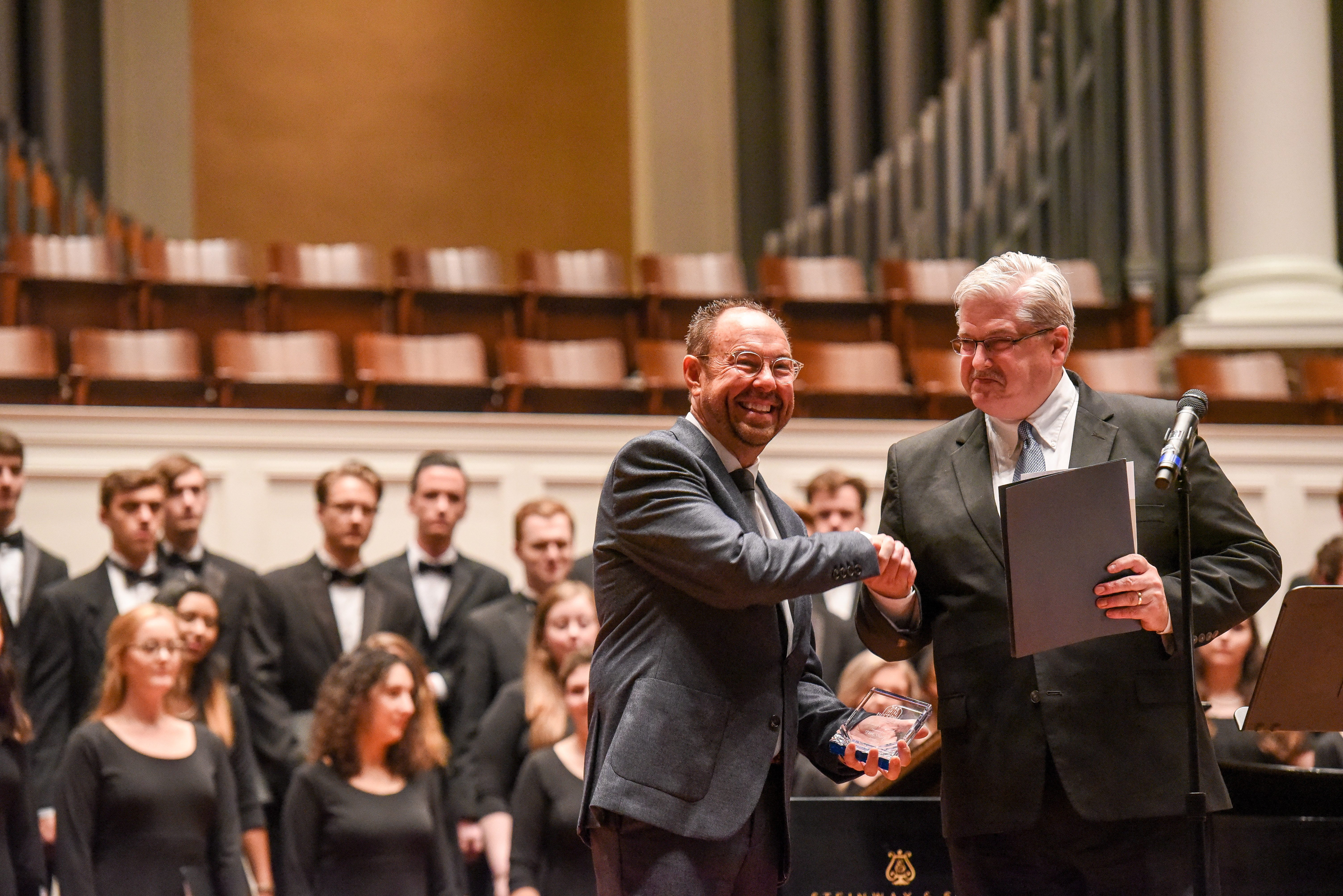 Sharp Receives his award from Dean of the College of Visual and Performing Arts Dr. Stephen Eaves on the stage of the McAfee Concert Hall.