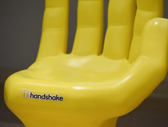 yellow plastic chair shaped like a hand