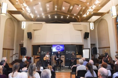 Students sing in the celebration of songwriting's ten years.