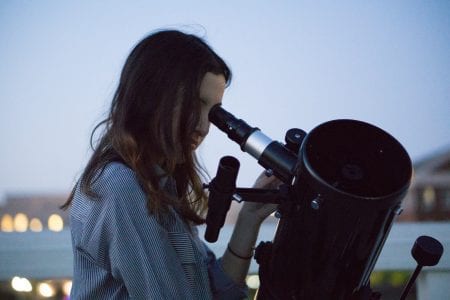 KC Katalbas looking into telescope