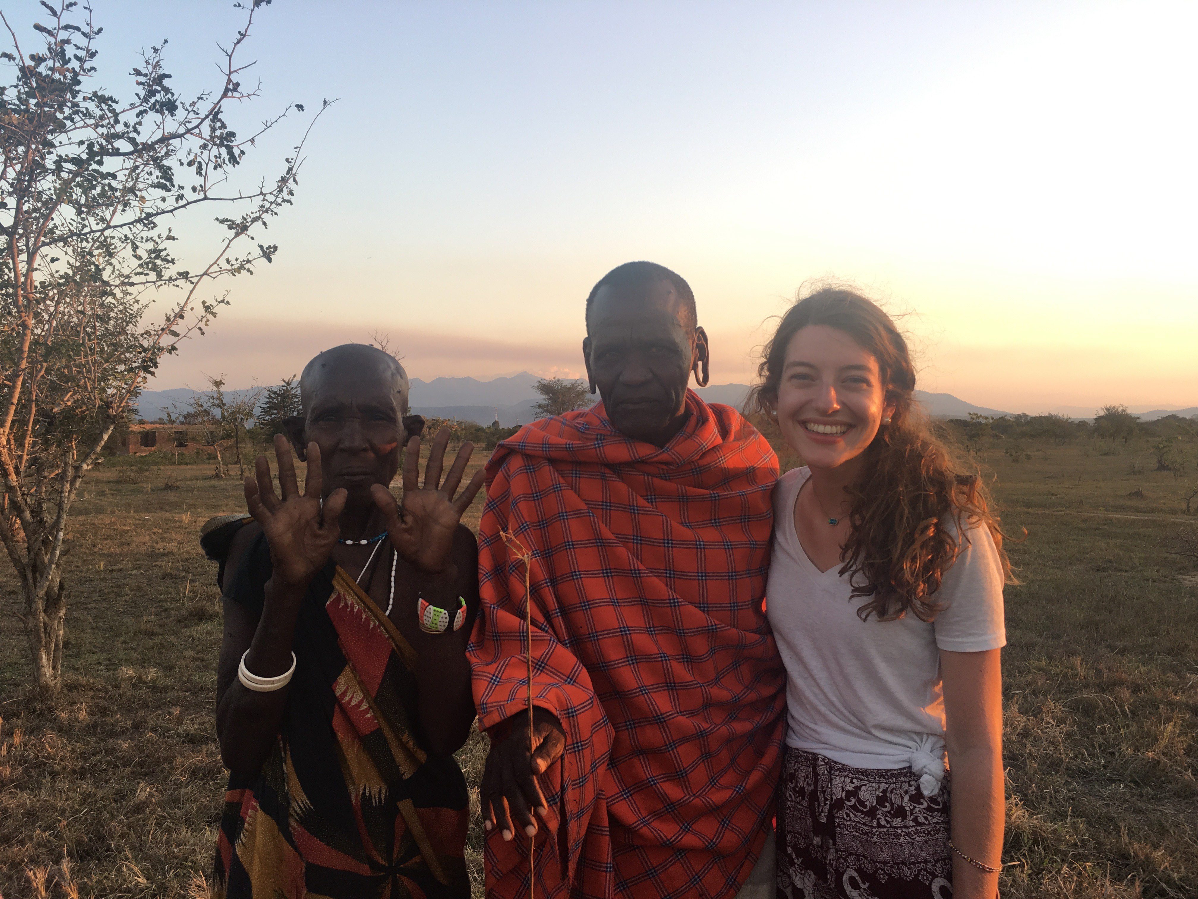 Karah Waters standing with two Tanzanians