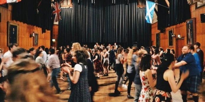 a ceilidh, a big room full of people dancing and eating
