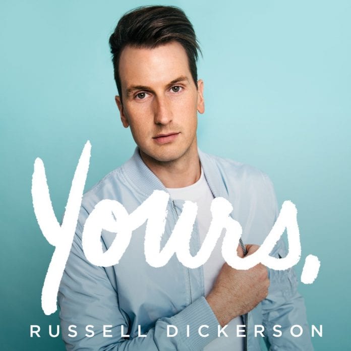 'Yours' album cover - Russel Dickerson in front of blue screen with the word 'Yours' written across the image.