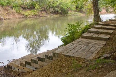 wooden steps leading down to a river