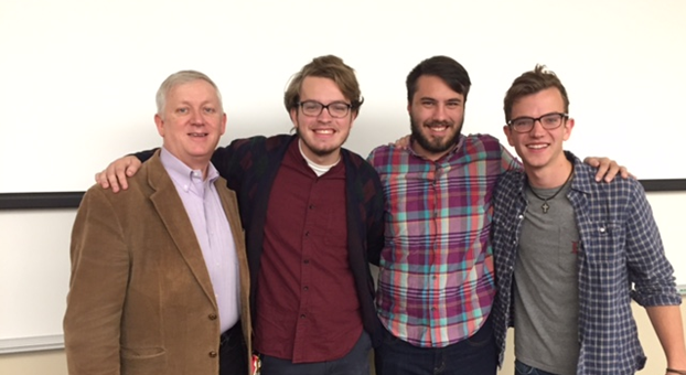 Dr. Darrell Gwaltne, Randy Westergaard, Cole Fuller, and Taylor Brown standing in a classroom
