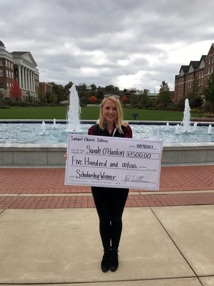 Sarah O'Hanlon holding over-sized scholarship check