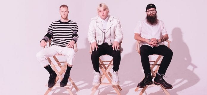 members of Judah and the Lion sitting in directors chairs, staring at the camera
