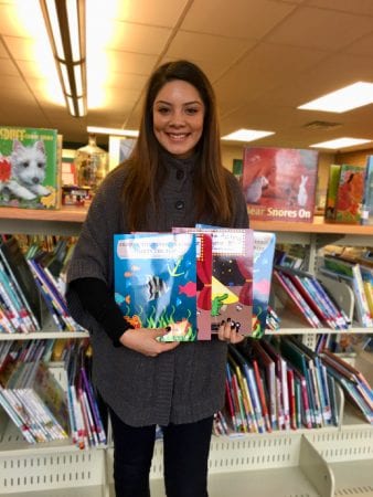 Crystal Lemus holding her books