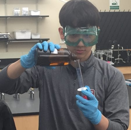 boy conducting a science experiment