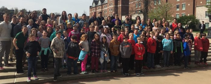 large group of fourth graders with their teachers, standing in front of the fountain