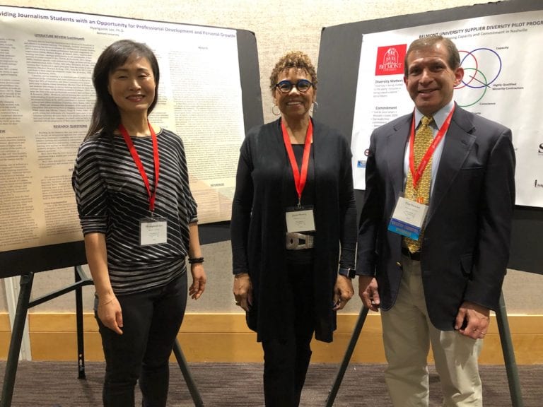 Joyce Searcy with Tim Stewart in front of informational poster boards