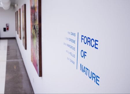 "Force of Nature" sticker on the wall, depicting the name of the event