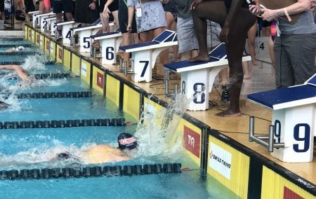 Caylix reaching the finish line in the pool