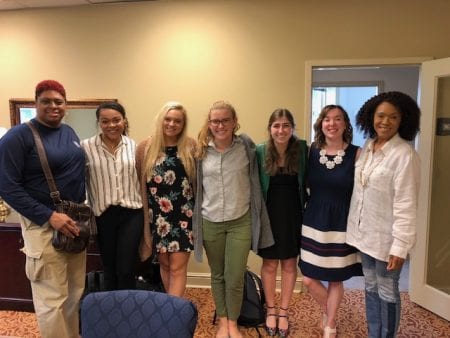 students standing and smiling with Easley representatives