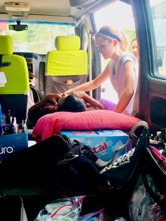 A FNP student examines a Cambodian patient in the back of her van -- getting creative with the resources she was given while on Maymester in Cambodia.