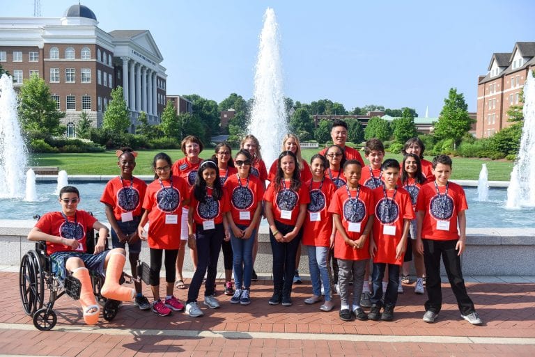 Students pose for a group picture in front of the Belmont fountain.