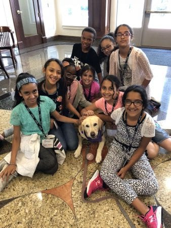 Students pose for a photo with Layla, the therapy dog! 