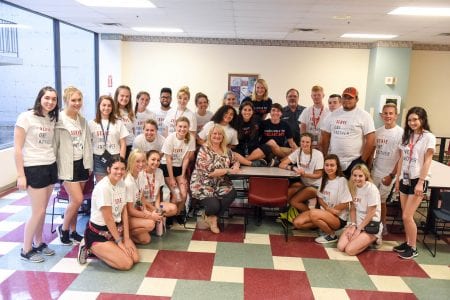 Group of Belmont students and Nashville General Hospital employees pose for group photo before working on service projects in the hospital.