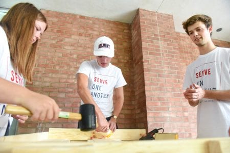 Belmont students use tools to build wooden bed frame for Sweet Sleep at Nashville First Baptist Church in Nashville, Tennessee.